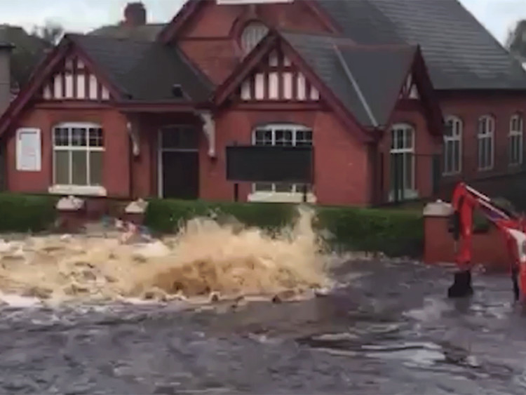 News: Residential street completely submerged in water after mains pipe bursts