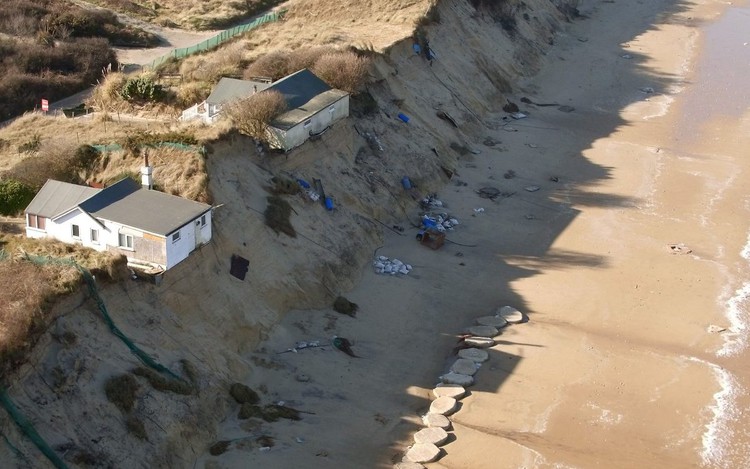 News: Clifftop residents refuse to leave their homes as Council warn they could fall into the sea